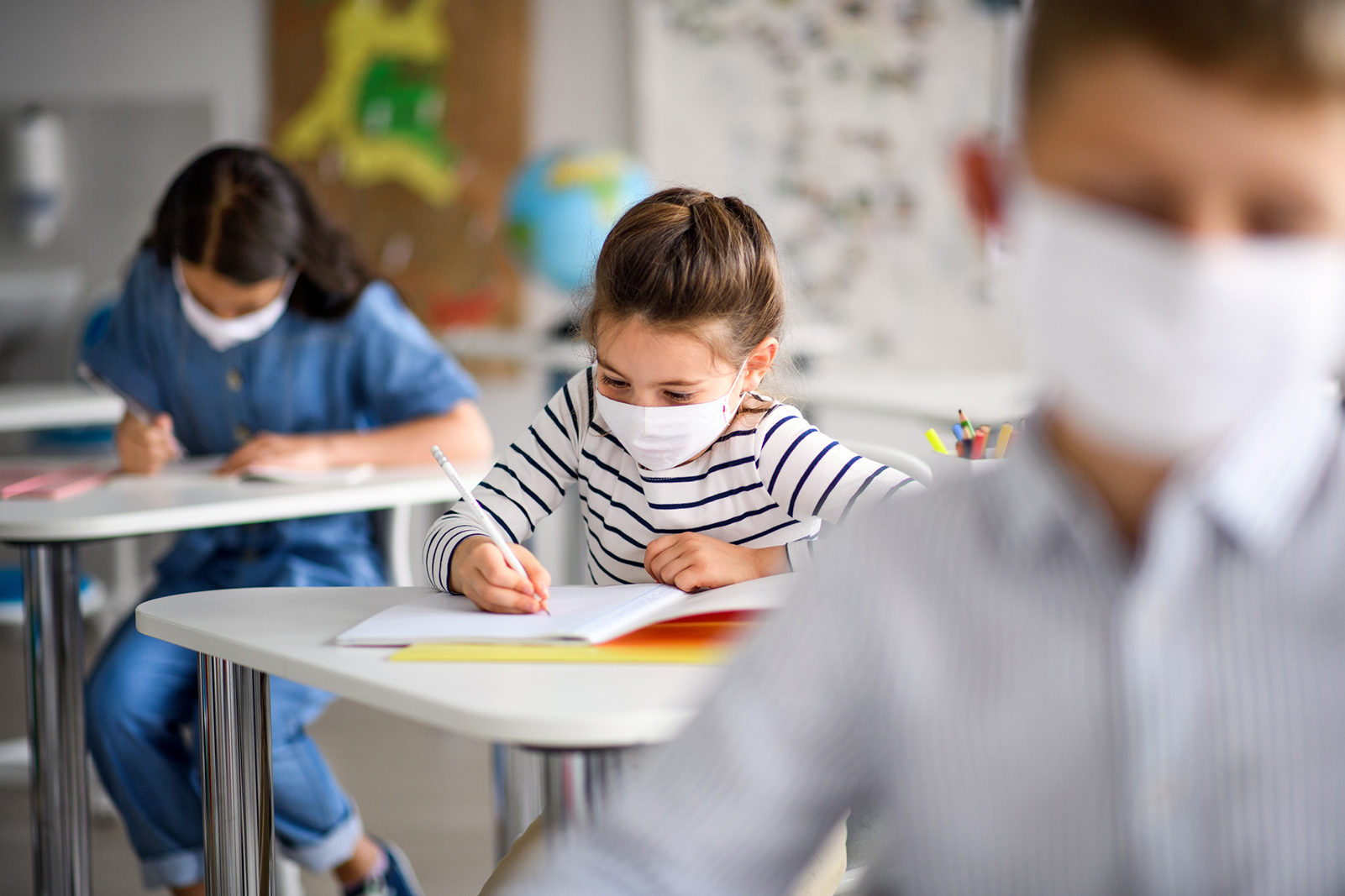 Children in class room with masks